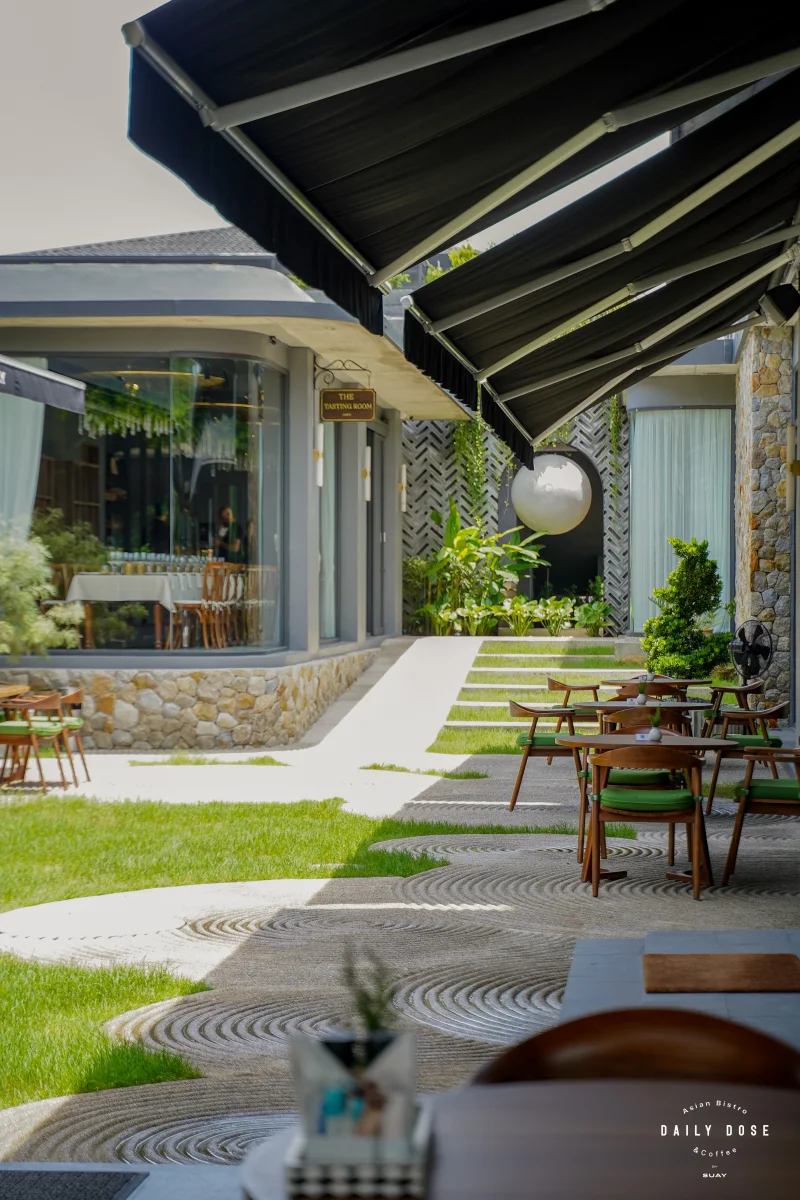 Garden path and outdoor tables beside the café glass front