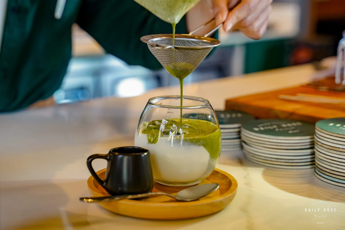 Matcha strained over milk and ice at the café bar