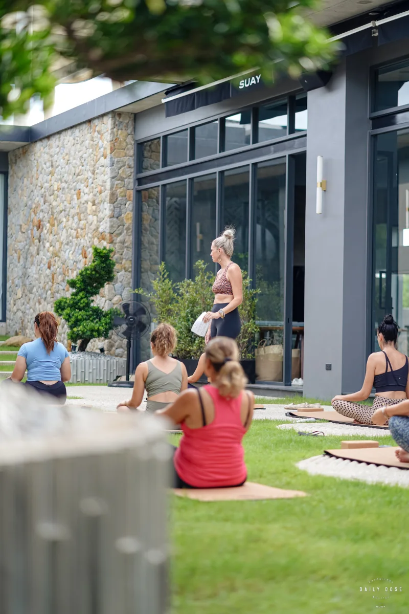 Guests at an outdoor yoga session on the lawn outside the café